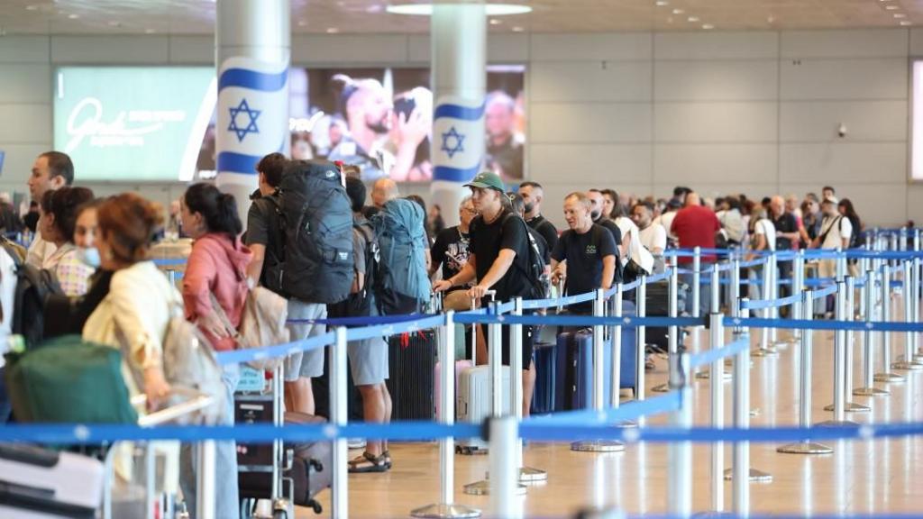 Passengers wait at the departures counters at the Ben Gurion International airport 